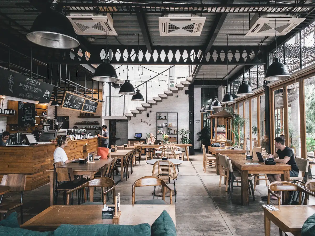 A bright café dining room with wooden tables