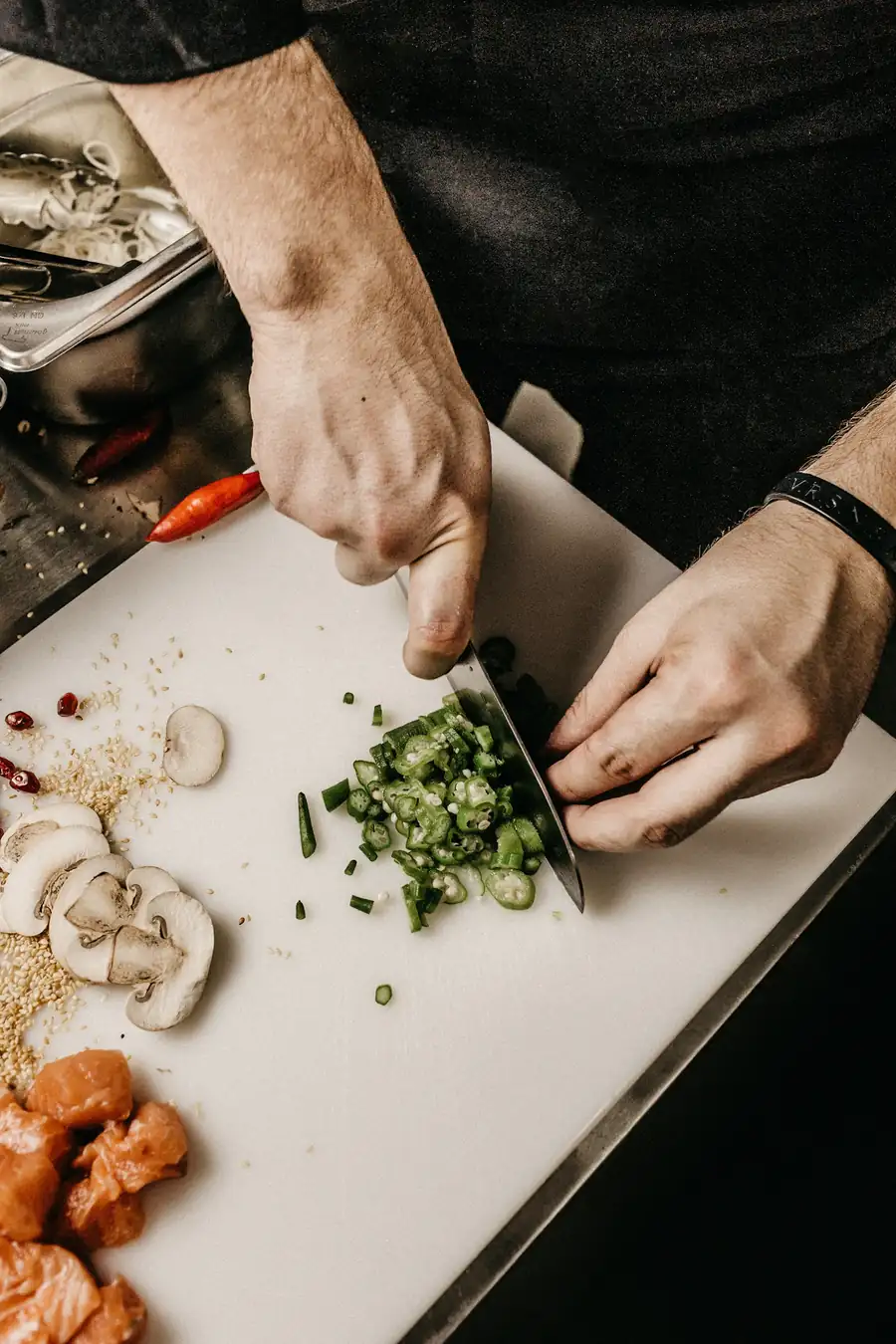 A chef chopping herbs on a board