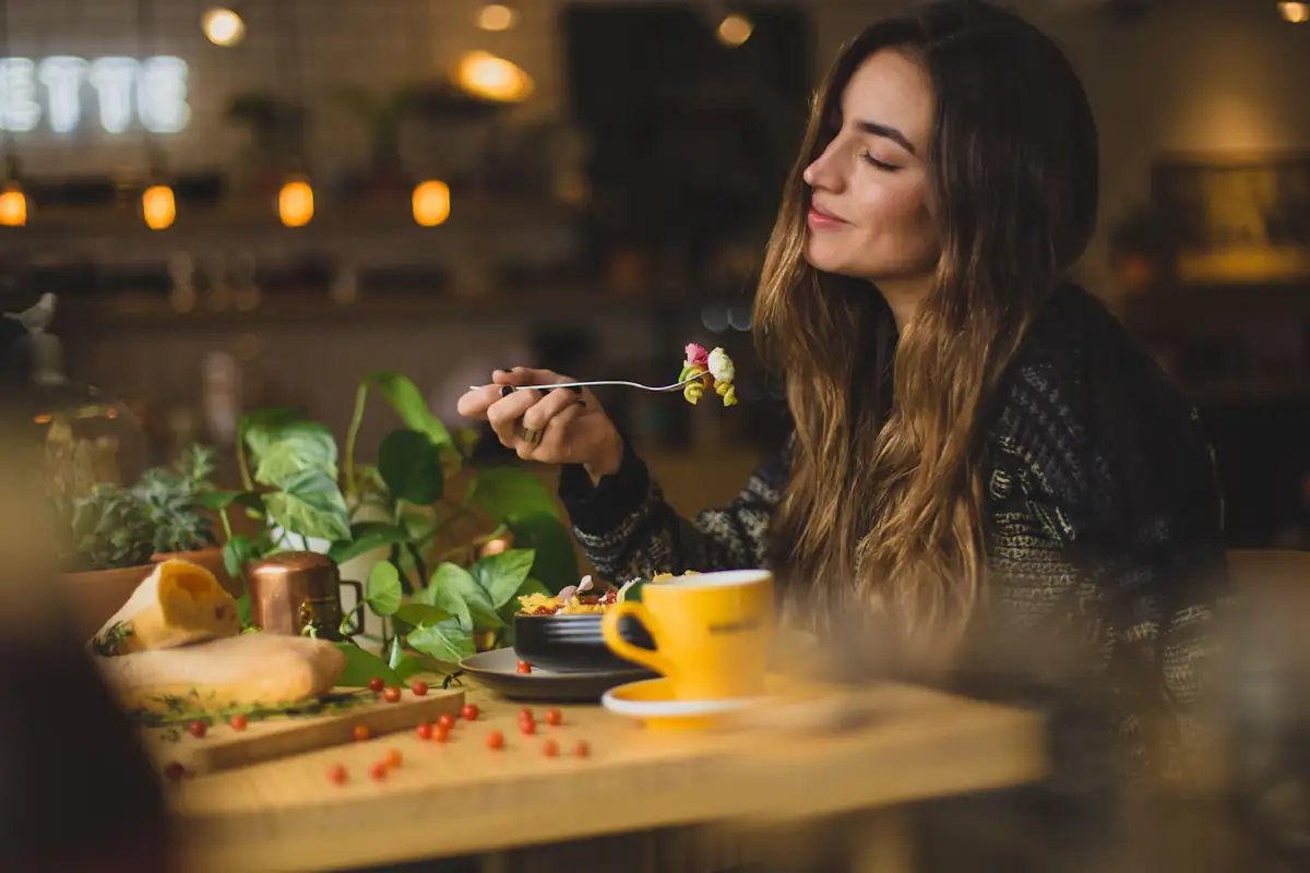 A guest enjoying dinner in a warmly lit restaurant