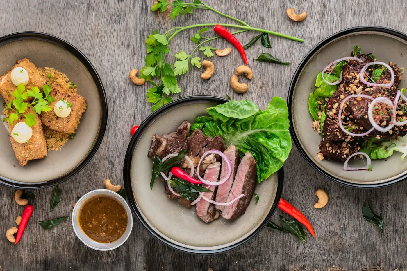 Plates of food shared across a dark wooden table