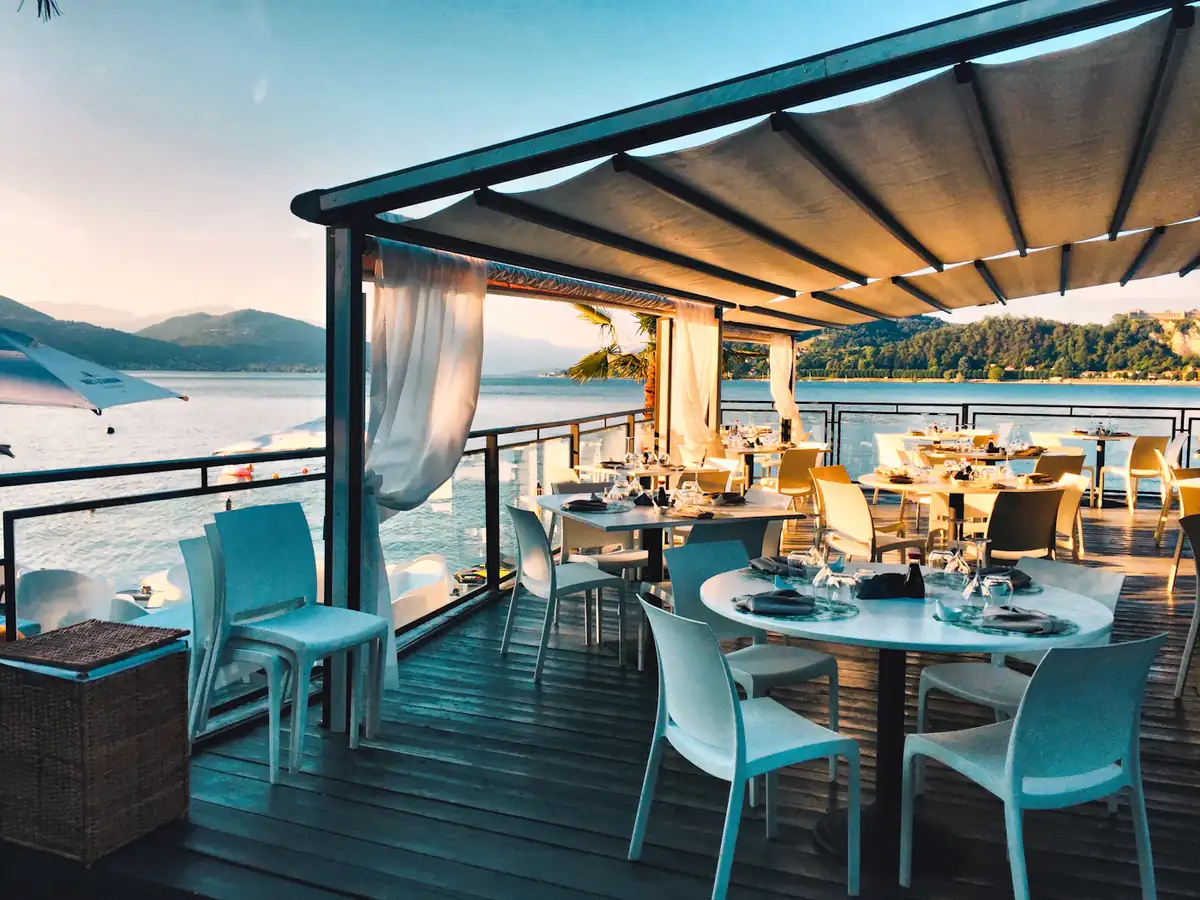 A seaside restaurant terrace set for dinner